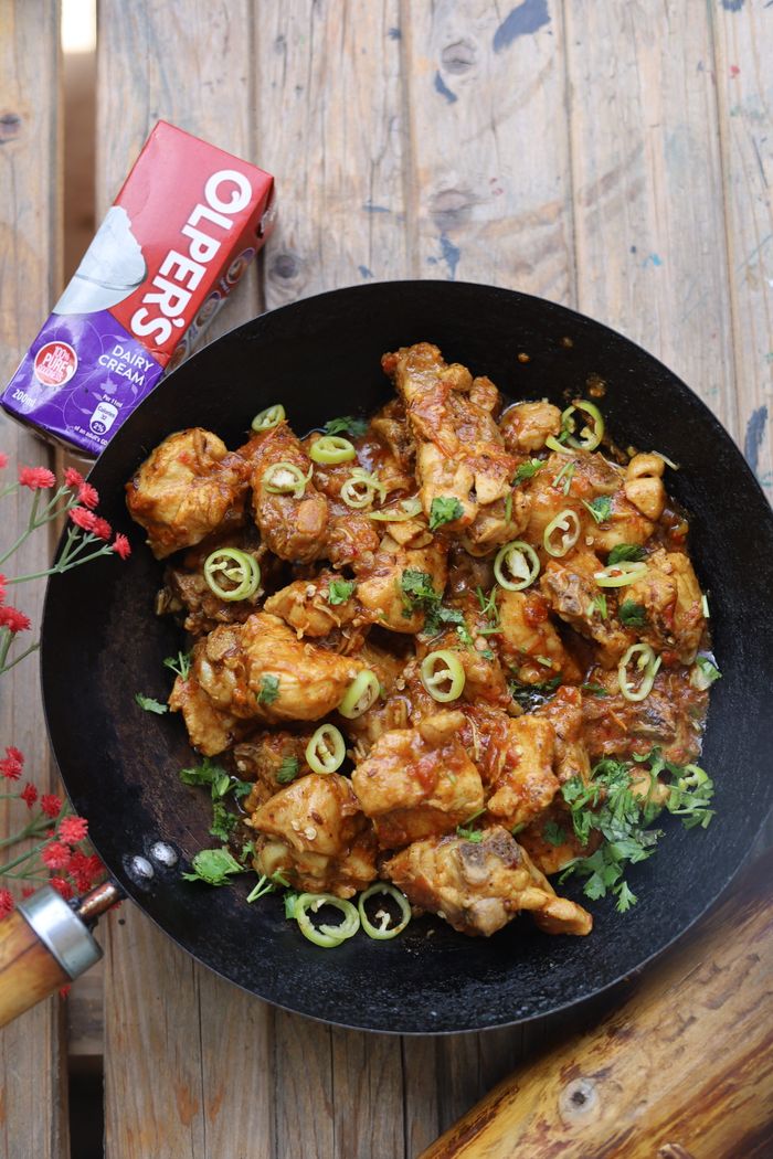 A vibrant chicken stir fry with spices and garnishing, perfect for culinary enthusiasts.